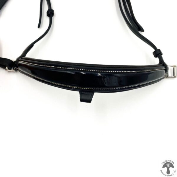 A black purse with a strap on the bottom of it.