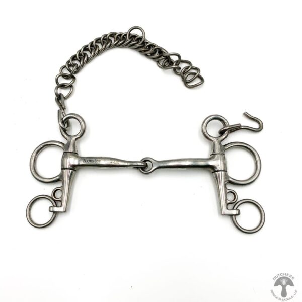 A close up of a horse bit with chain