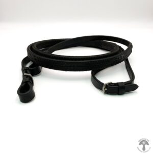 A black leather leash is laying on the ground.