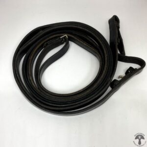 A black leather dog leash laying on top of a table.