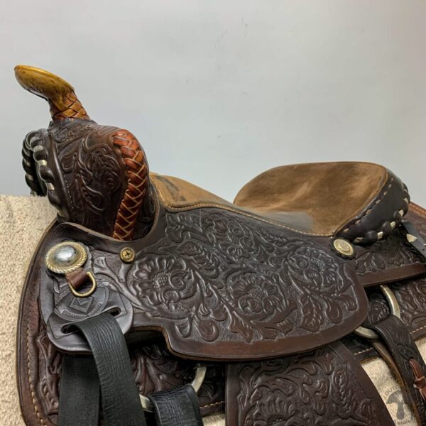 A close up of the saddle on a horse