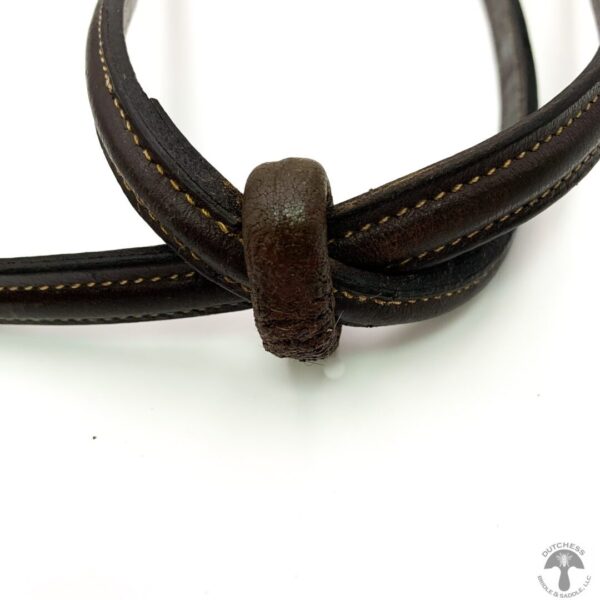 A close up of the end of a brown leather cord