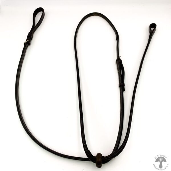 A black rope is tied to the end of a leash.