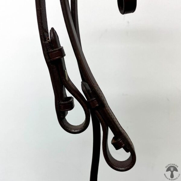 A close up of the handles on a horse bridle