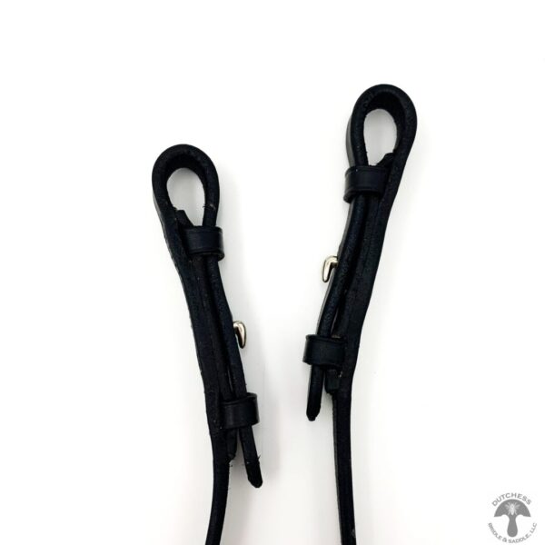 A pair of black plastic handles on a white background.