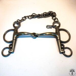 A metal horse bit with chain hanging off of it.