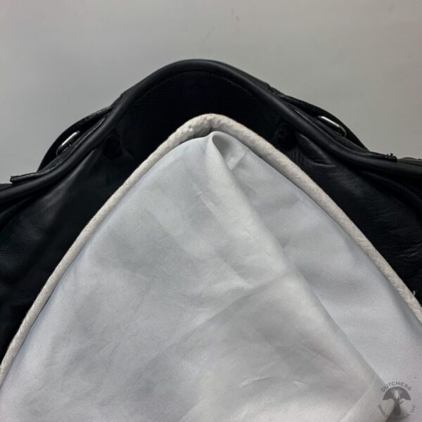 A black bag and white cloth on the bottom of it.