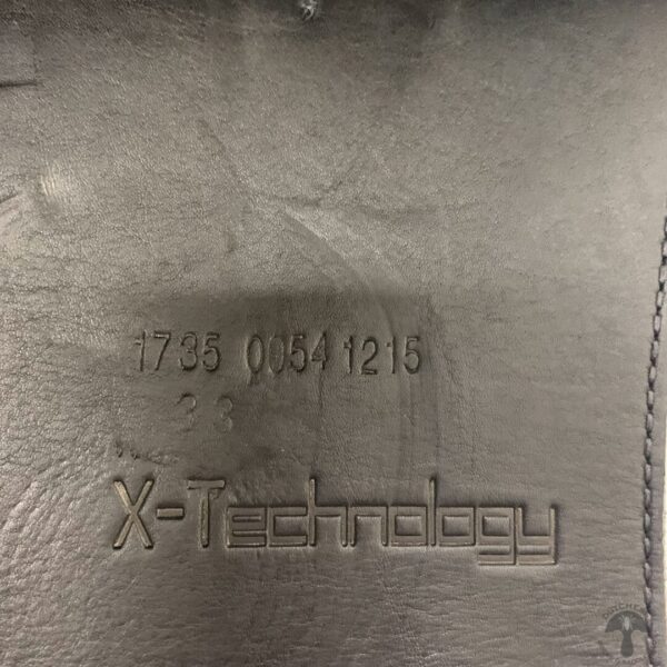 A close up of the back side of an x-technology bag.