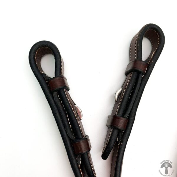 A pair of black leather straps with brown accents.