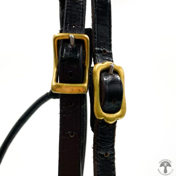 A pair of black leather straps with gold buckles.