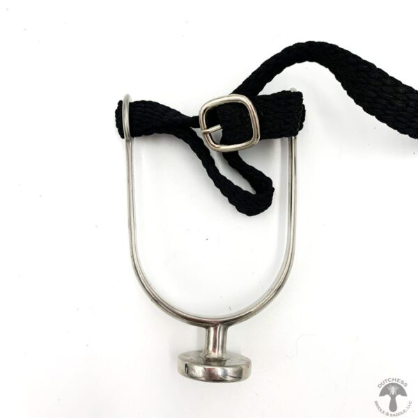 A black rope hanging from the side of a metal object.