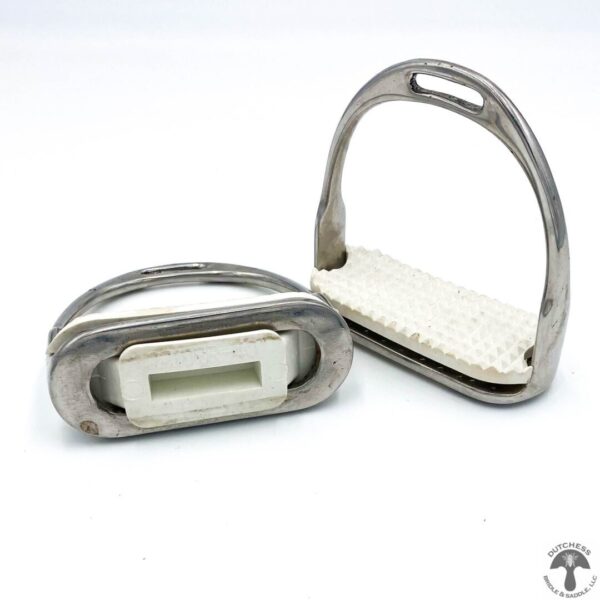 A pair of metal horse stirrups with white numbers.