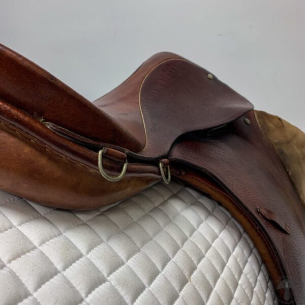 A close up of the saddle on a horse