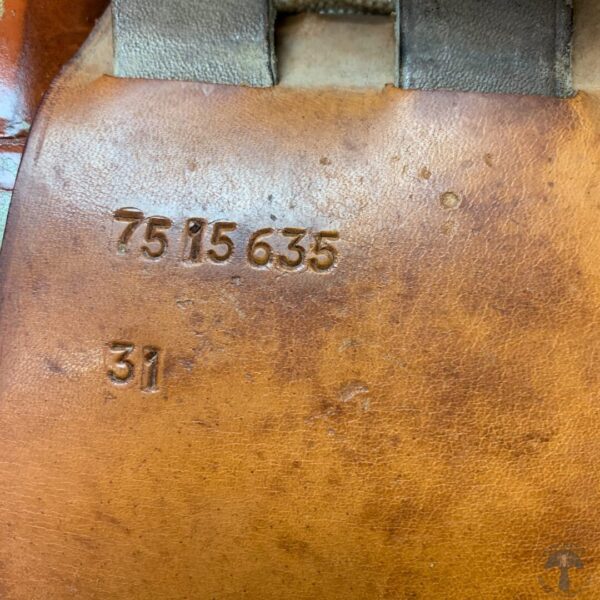 A close up of the numbers on a brown leather bag