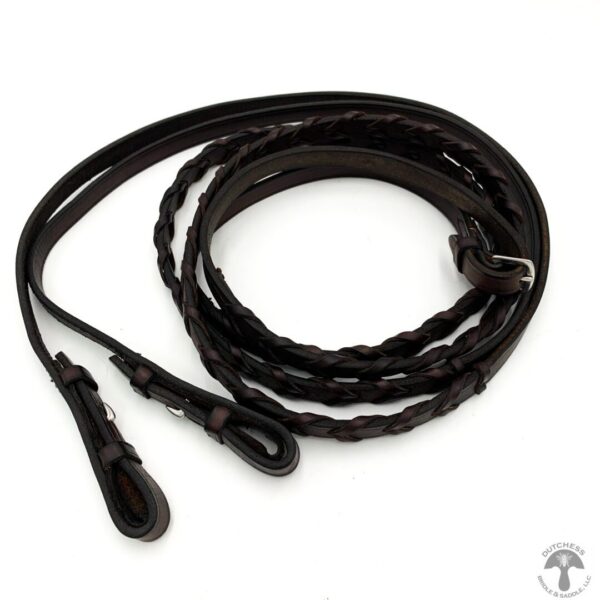 A close up of a leather whip on a white background