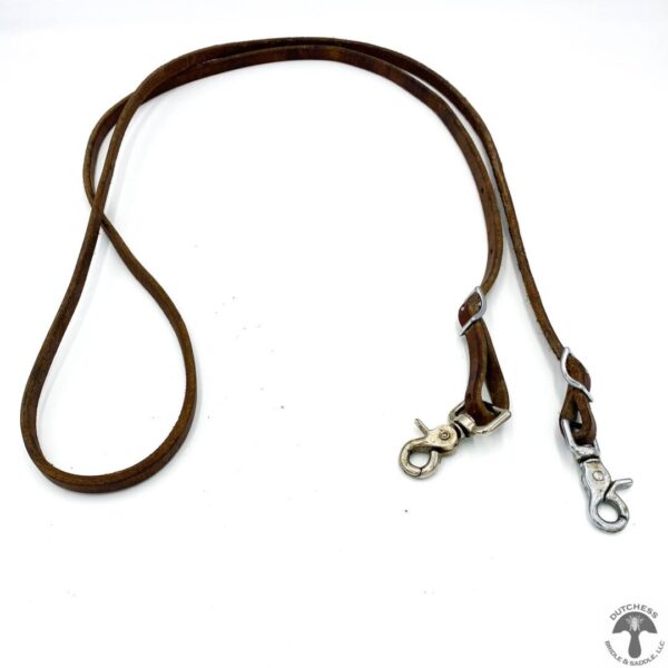 A brown leather dog leash with silver hardware.