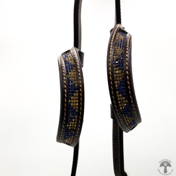 A pair of black and blue patterned straps hanging from a string.