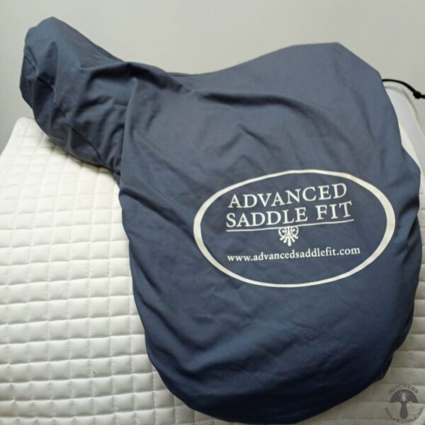 A blue saddle cover on top of a white mattress.