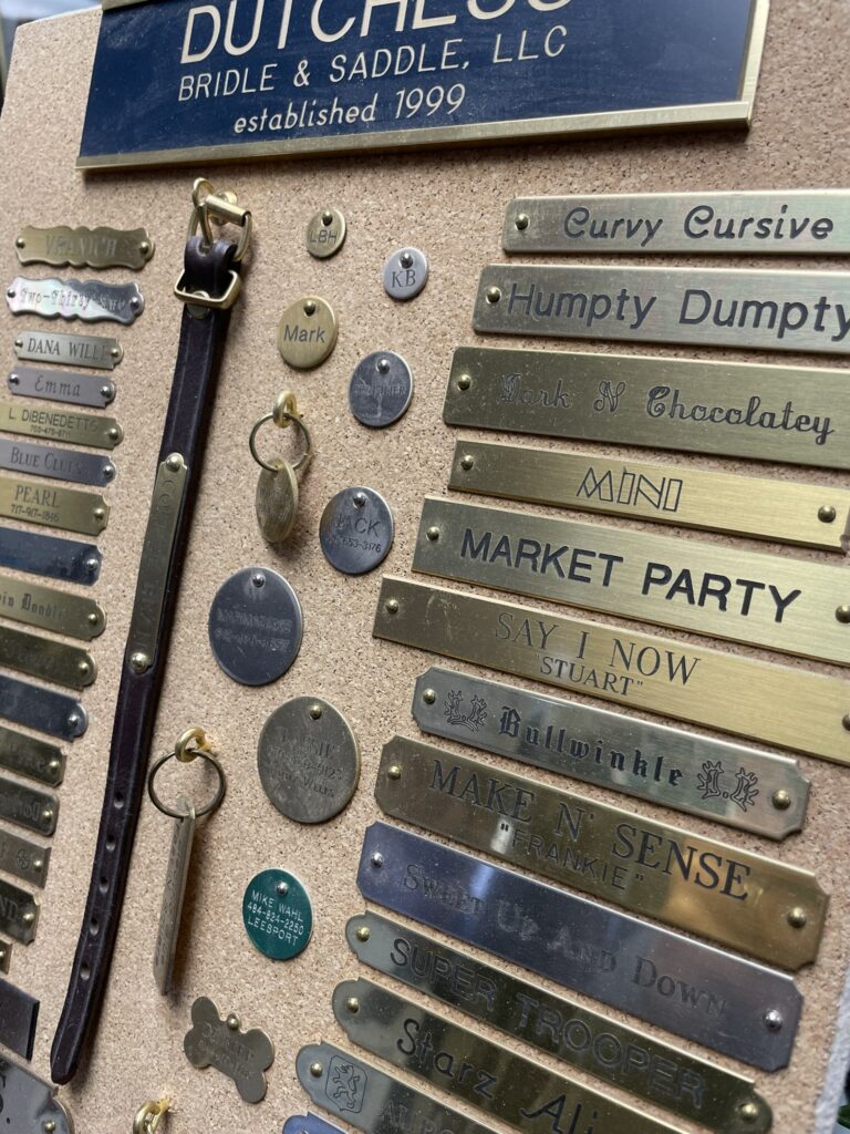 A table with many different metal tags and some keys