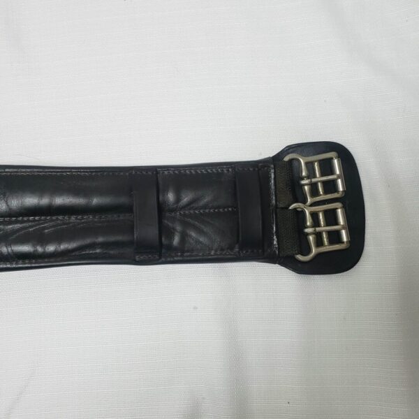 A close up of the back end of a black leather belt