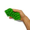 A hand holding a green toy in the shape of an alligator.