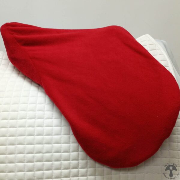 A red blanket on top of a bed.