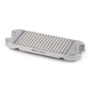 A silver grate sitting on top of a white surface.