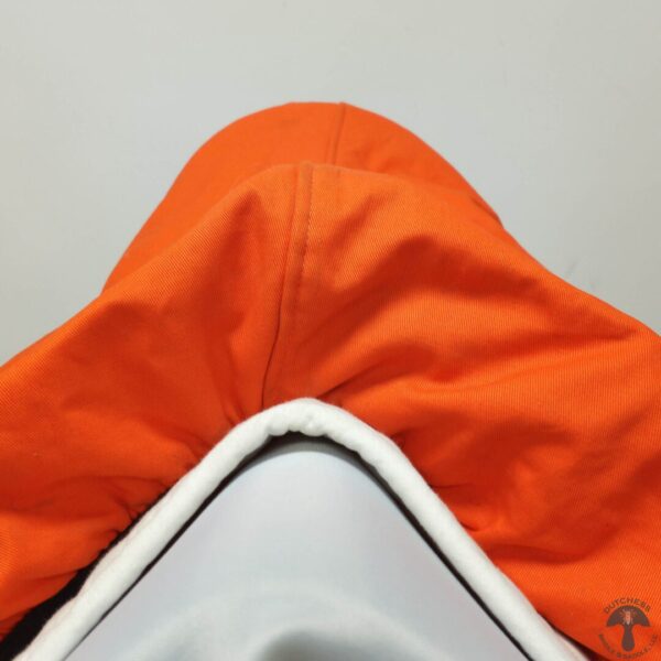 A close up of the hood on an orange hat